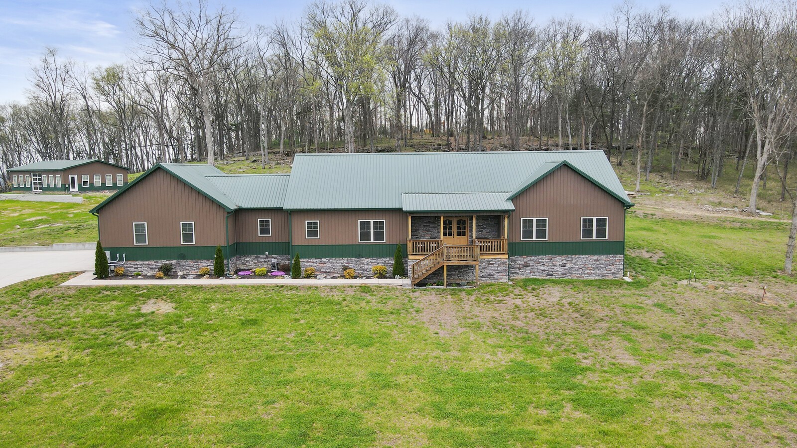a front view of a house with yard and tree s