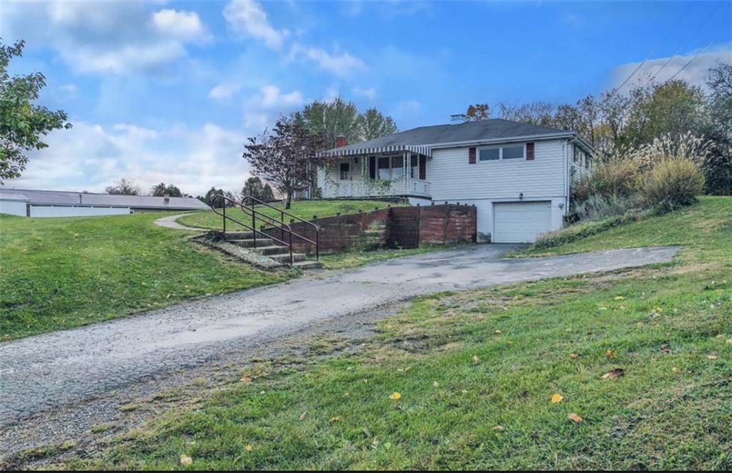 129 Shaffer Road Apollo, PA 15613 - Photo 19 of 25 a view of a white house next to a yard with big trees