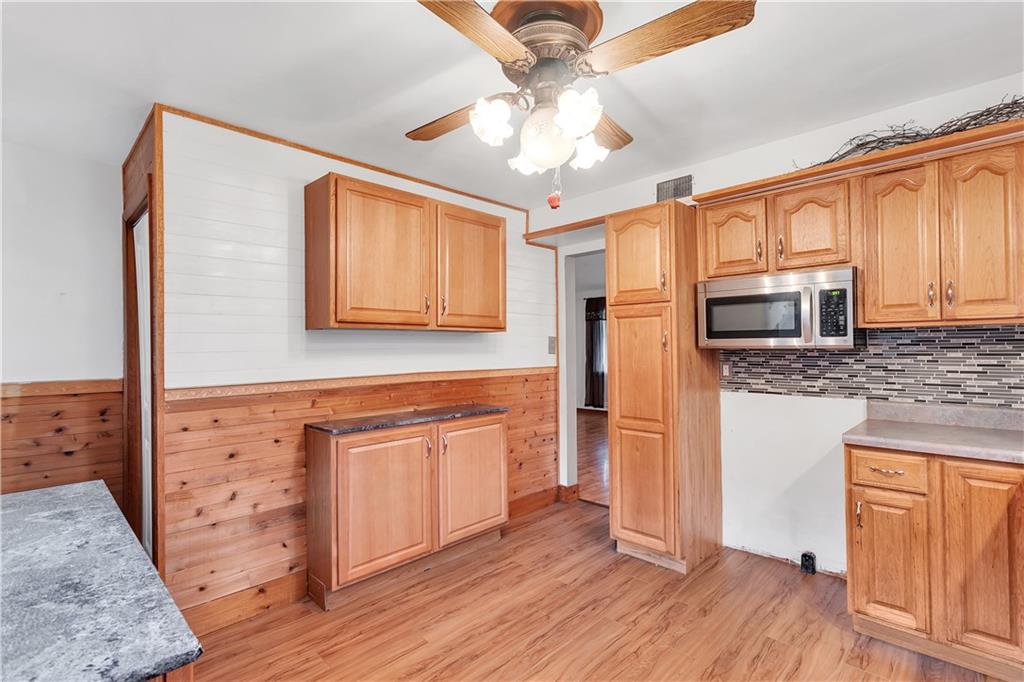 129 Shaffer Road Apollo, PA 15613 - Photo 7 of 25 a kitchen with stainless steel appliances granite countertop a stove top oven a refrigerator cabinets and wooden floor