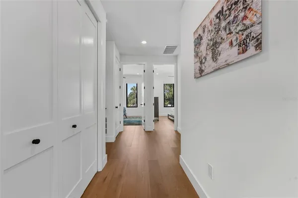 a view of a hallway with wooden floor