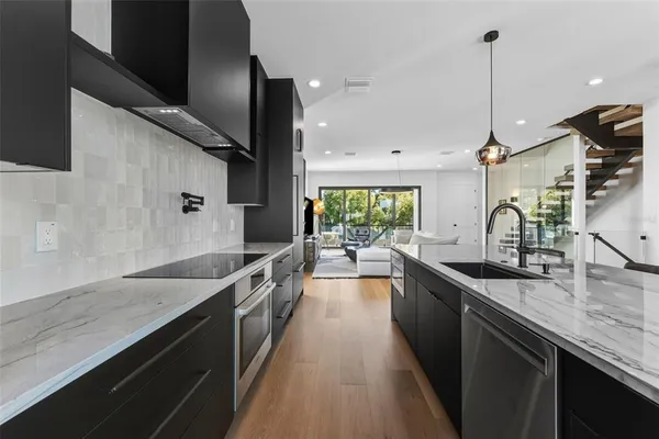 a kitchen with counter top space a sink and appliances