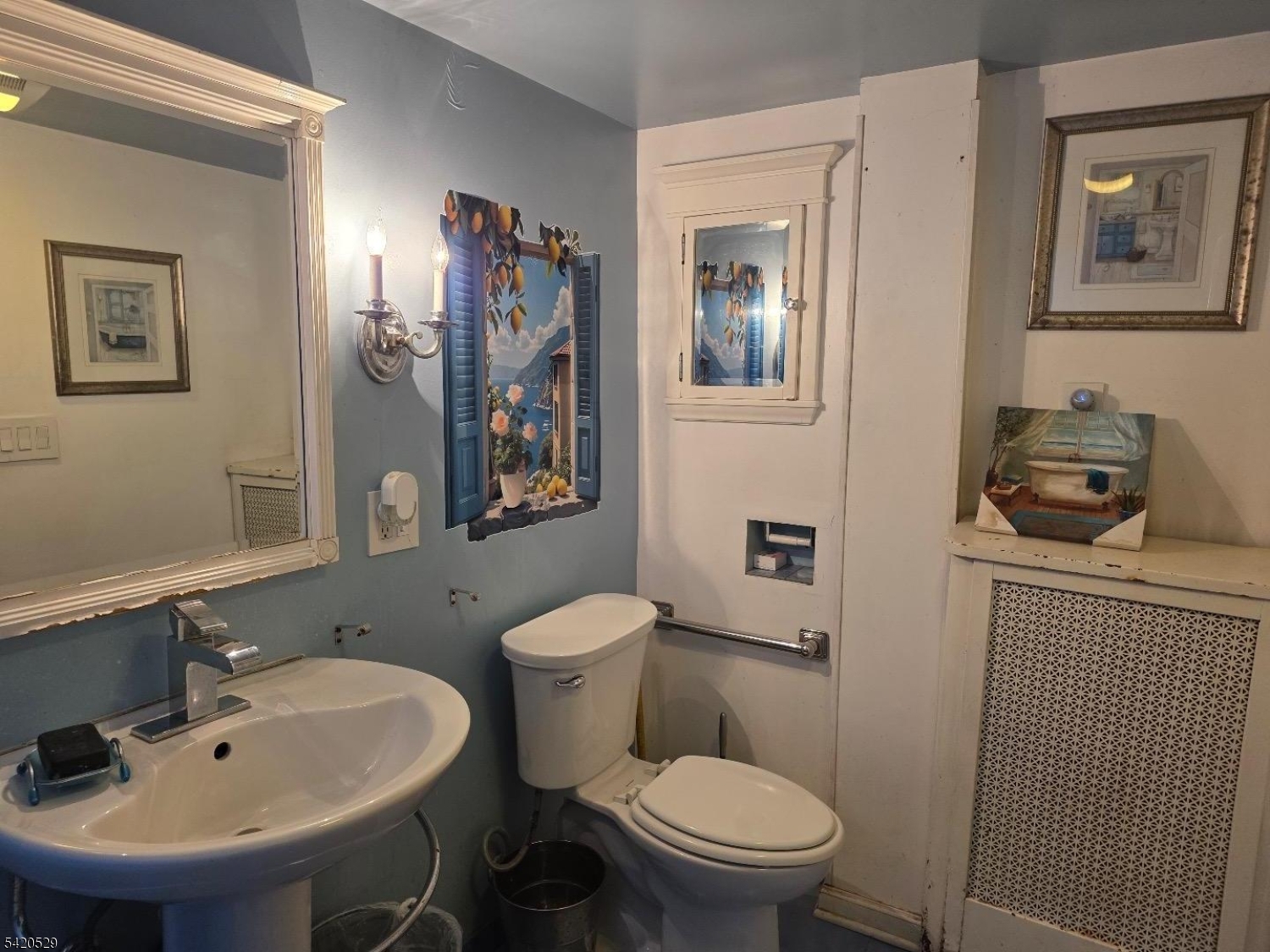 78 William Street Orange, NJ 07050 - Photo 4 of 4 a bathroom with a toilet a sink and mirror