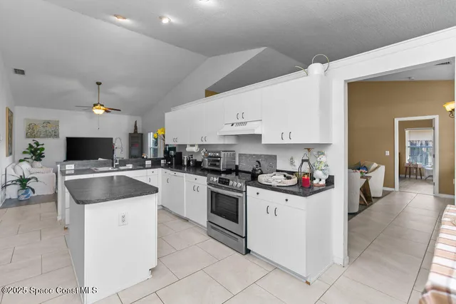 a kitchen with a sink and white cabinets