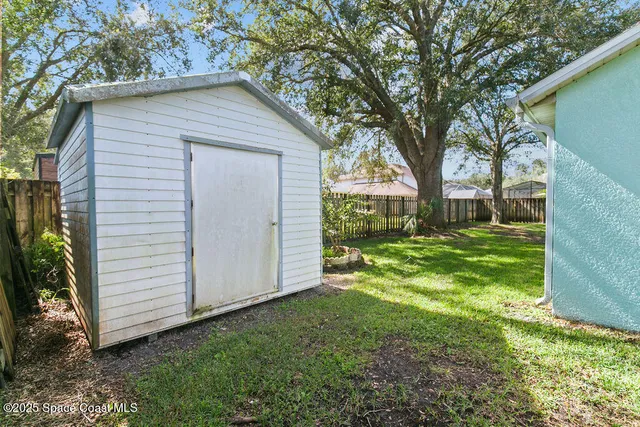 a view of backyard of house with green space
