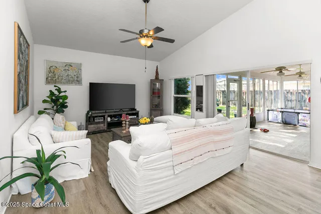 a living room with fireplace furniture and a flat screen tv