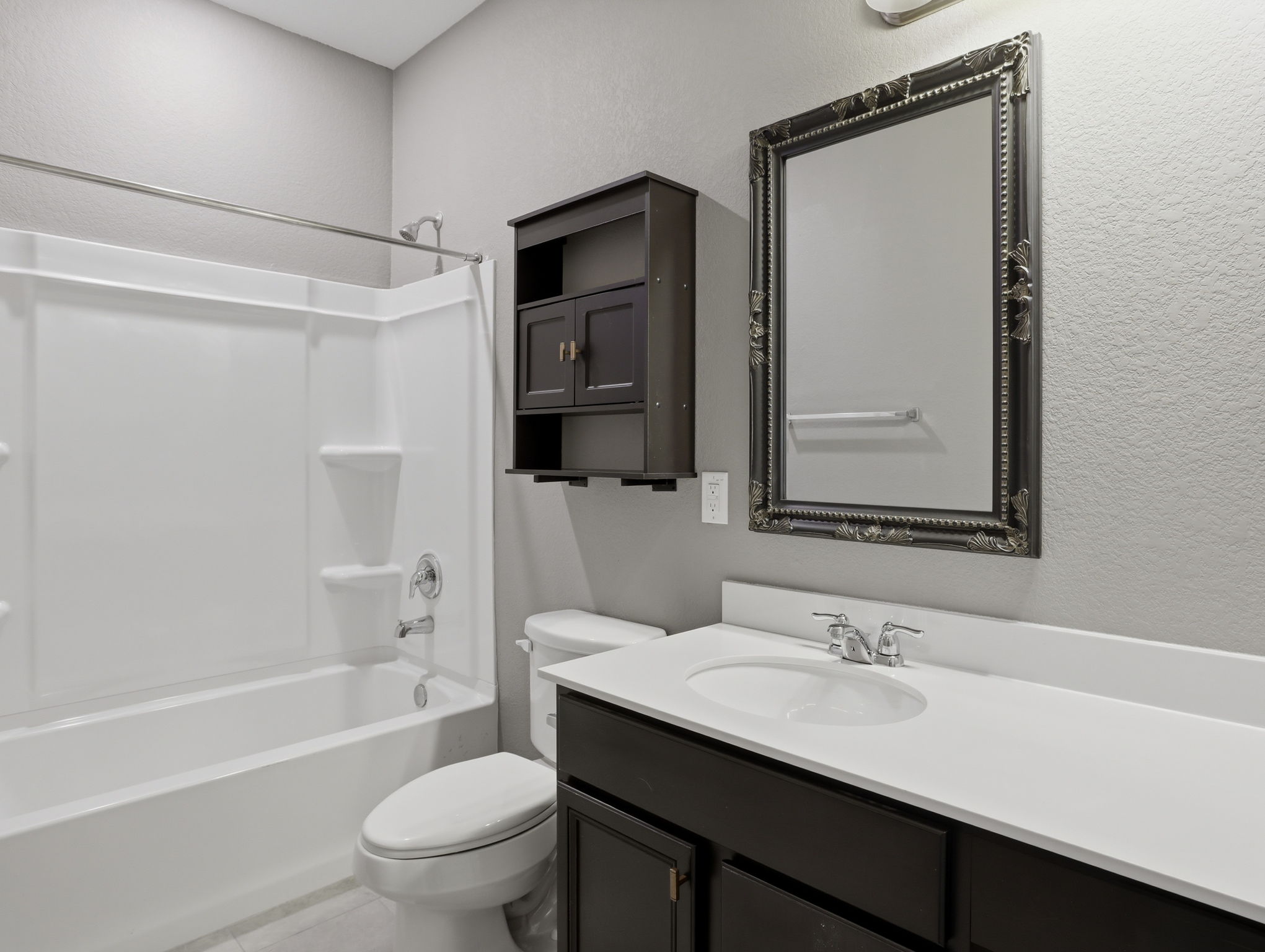 640 Landon Samuel Loop Pflugerville, TX 78660 - Photo 24 of 33 Bathroom featuring a white integrated tub and shower unit with chrome fixtures