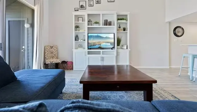 a living room with furniture and wooden floor