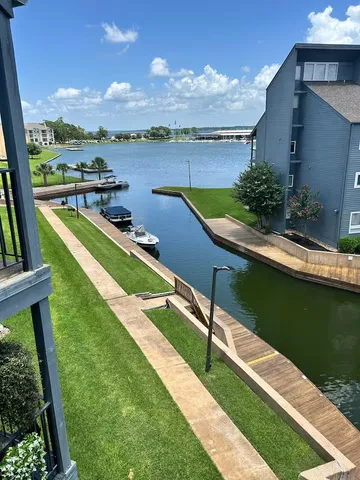 a view of a lake with couches and wooden floor