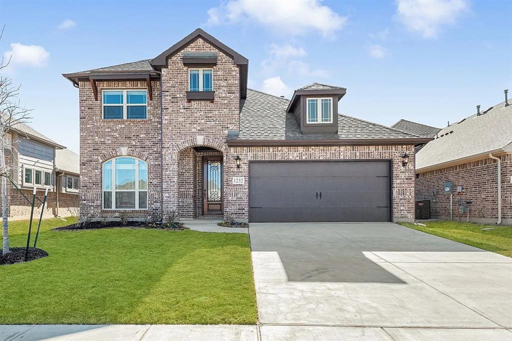 1232 Starlight Avenue Aubrey, TX 76227 - Photo 1 of 22 a front view of a house with a yard and garage