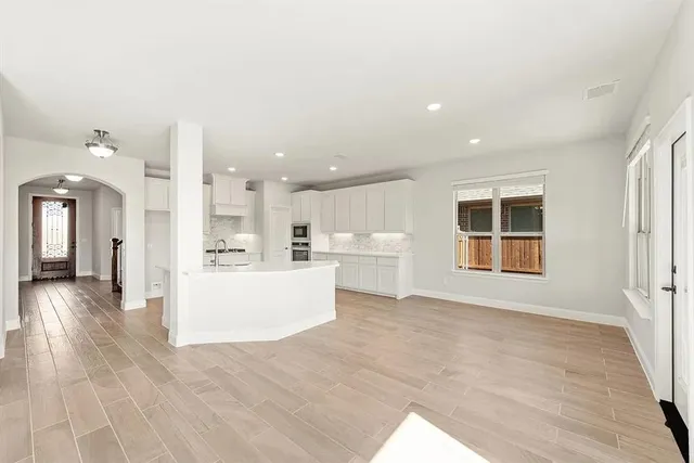 a view of a living room and kitchen with furniture floor to ceiling window