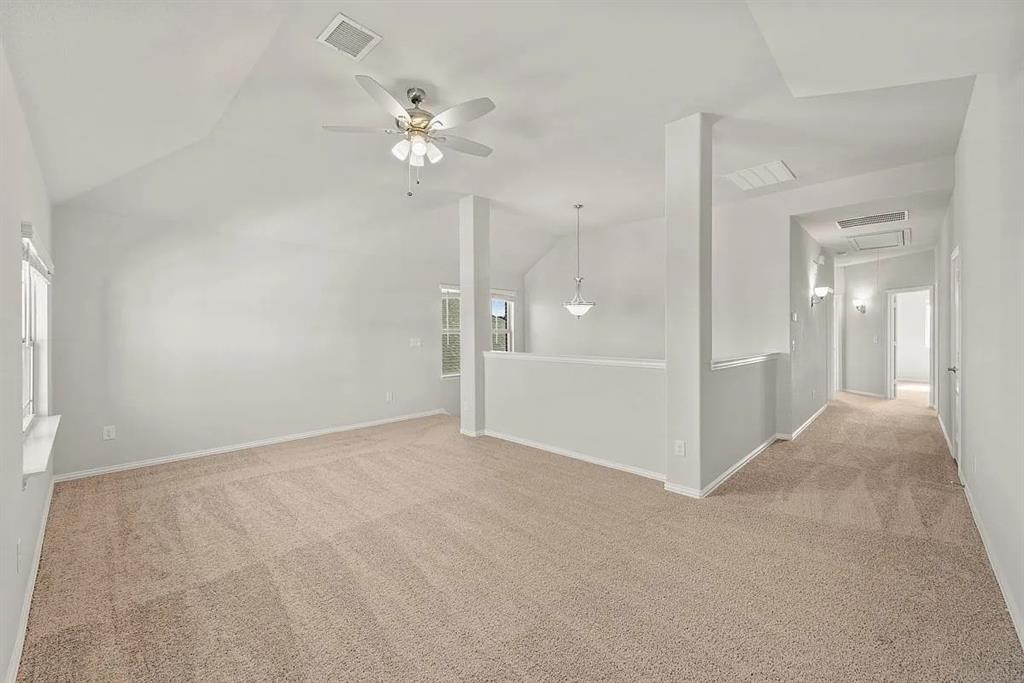 1232 Starlight Avenue Aubrey, TX 76227 - Photo 18 of 22 a view of an empty room with a chandelier fan