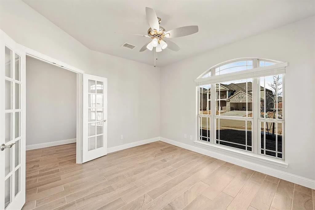 1232 Starlight Avenue Aubrey, TX 76227 - Photo 6 of 22 wooden floor in an empty room with a window