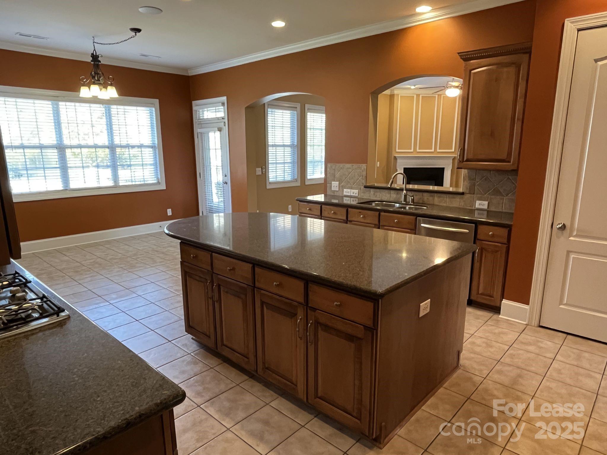 11502 Wheat Ridge Road Charlotte, NC 28277 - Photo 19 of 47 a kitchen with kitchen island granite countertop a stove and a sink