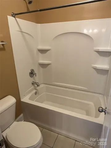 a bathroom with a toilet and a bathtub