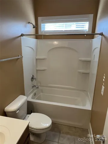 a bathroom with a toilet and a bathtub