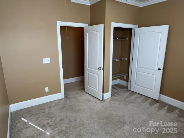 an empty room with closet and mirror