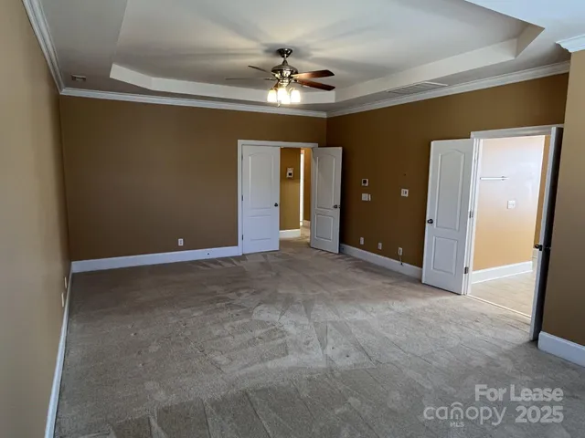 a view of a livingroom with a ceiling fan window and a chandelier