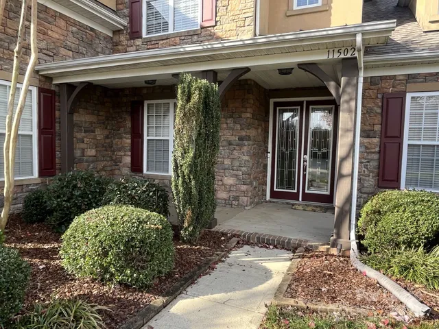 front view of a brick house with a large window