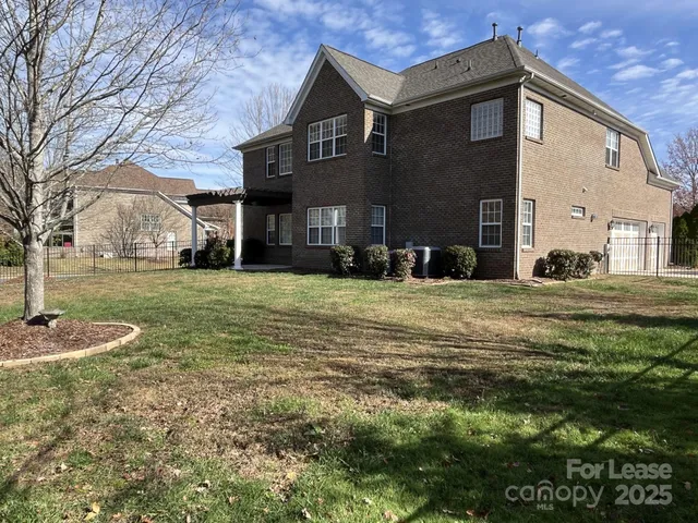a view of a big house with a yard
