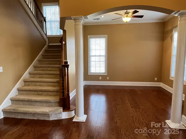 a view of entryway and hall with wooden floor