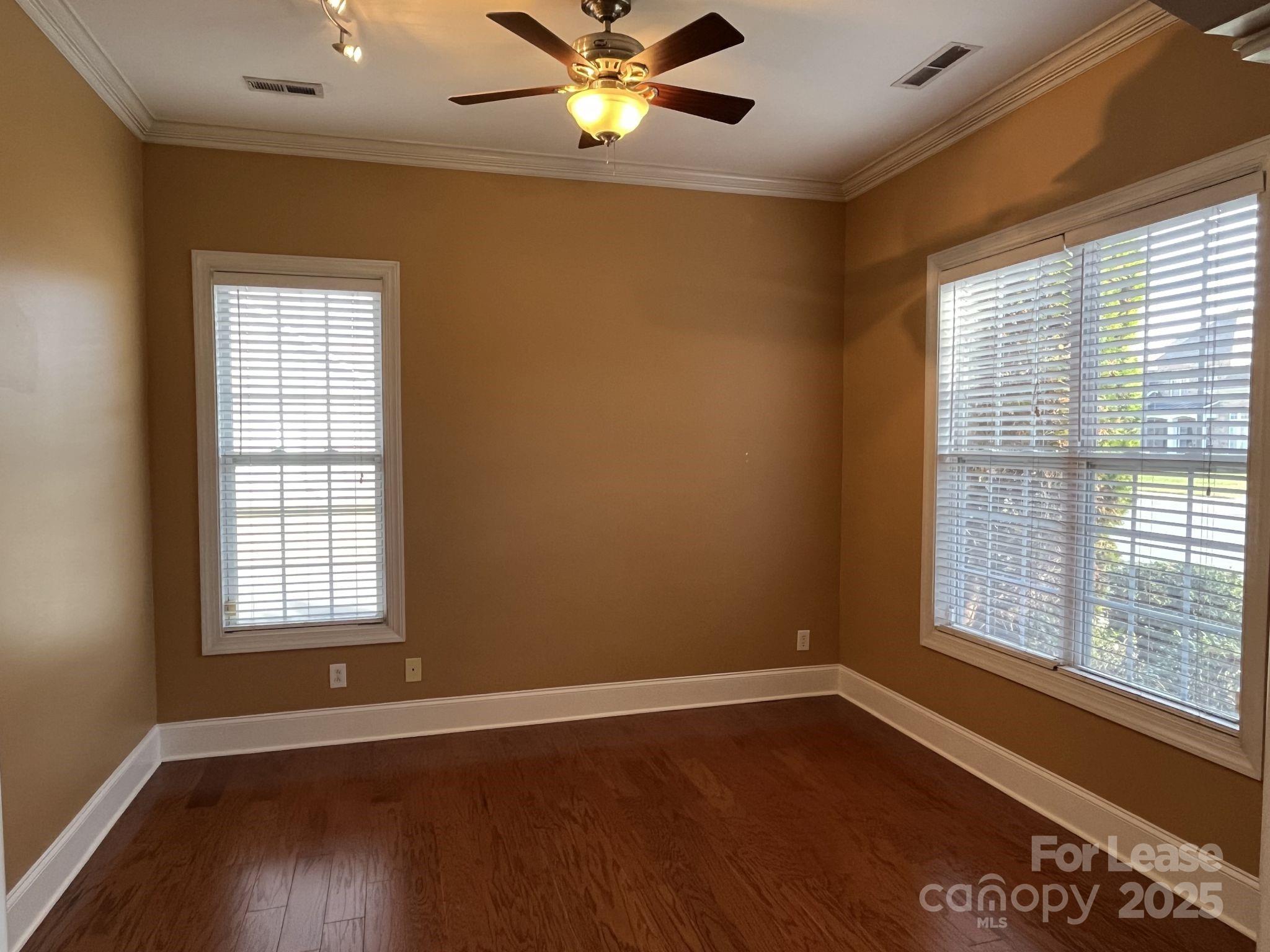 11502 Wheat Ridge Road Charlotte, NC 28277 - Photo 10 of 47 a view of an empty room with wooden floor and a window