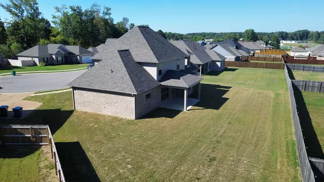 an aerial view of a house with yard swimming pool and outdoor seating