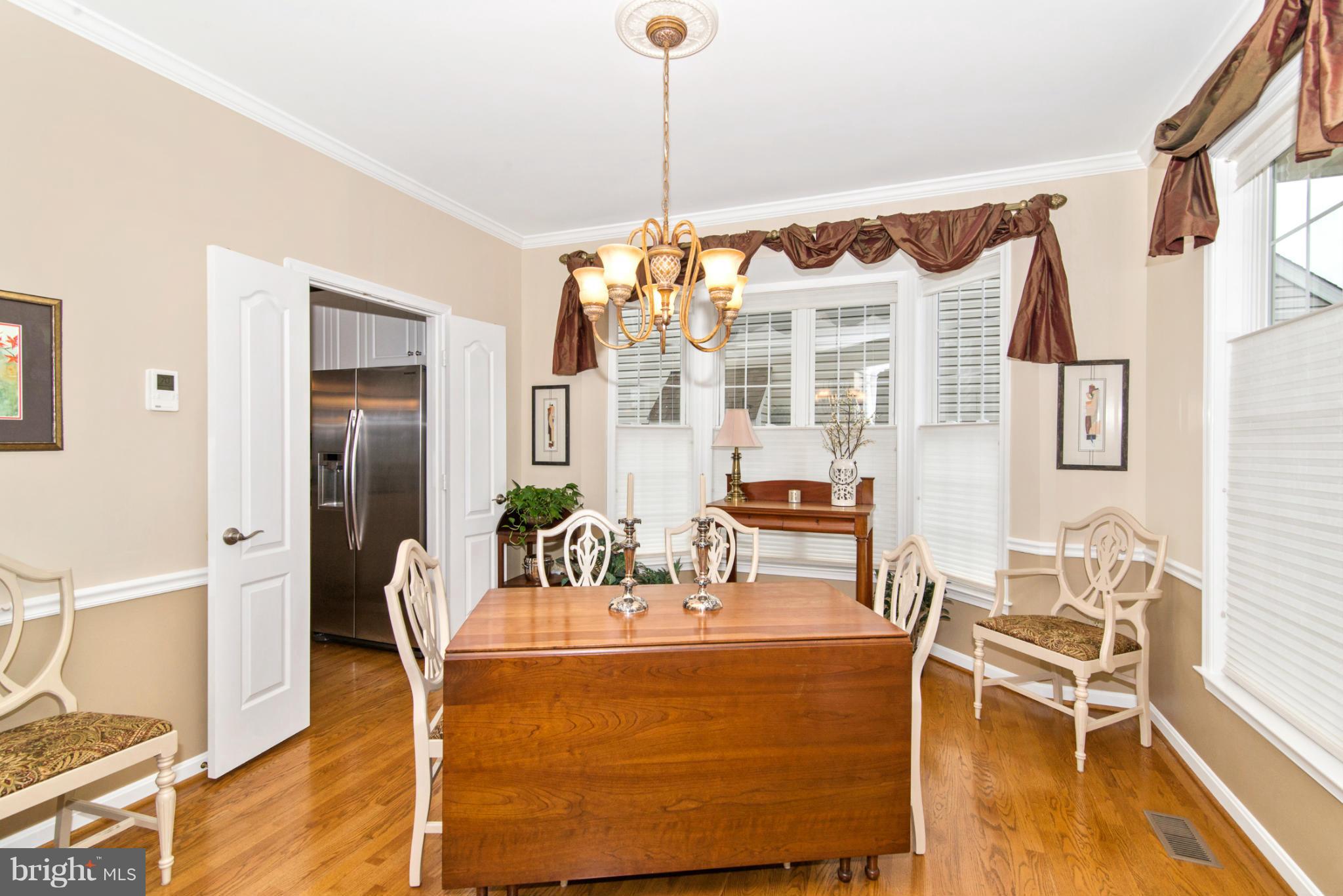 2519 Bear Den Road Frederick, MD 21701 - Photo 11 of 30 a view of a dining room with furniture a chandelier and wooden floor
