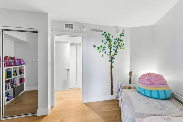 a bedroom with furniture and a potted plant