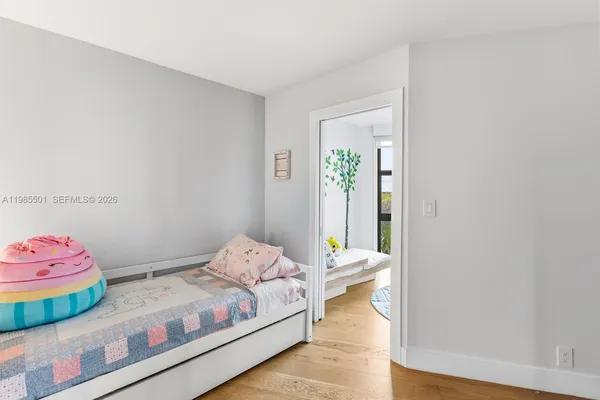 a bedroom with bed and a window