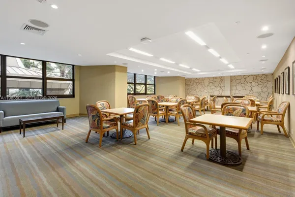 a dining room with furniture a rug and wooden floor