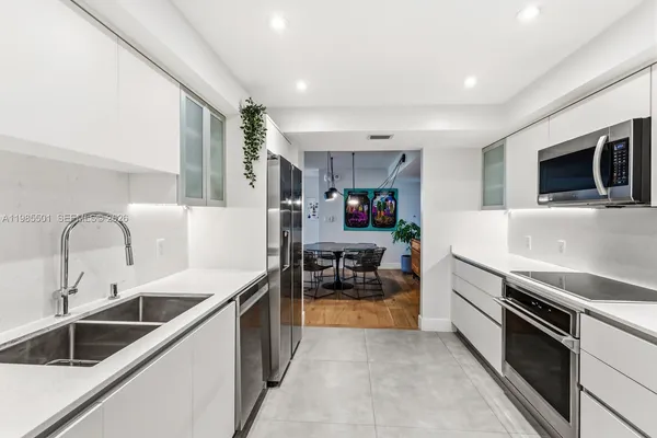 a kitchen with a sink and appliances