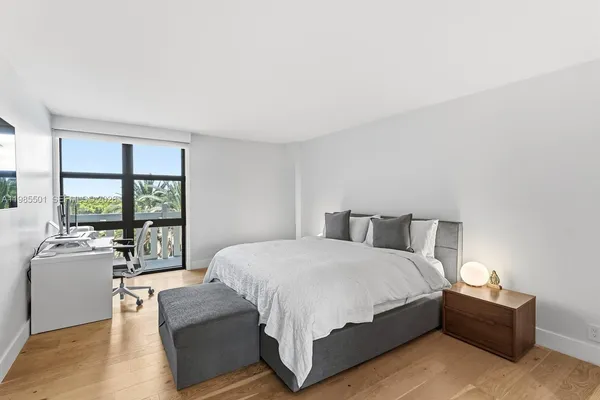 a bedroom with a large bed and a large window