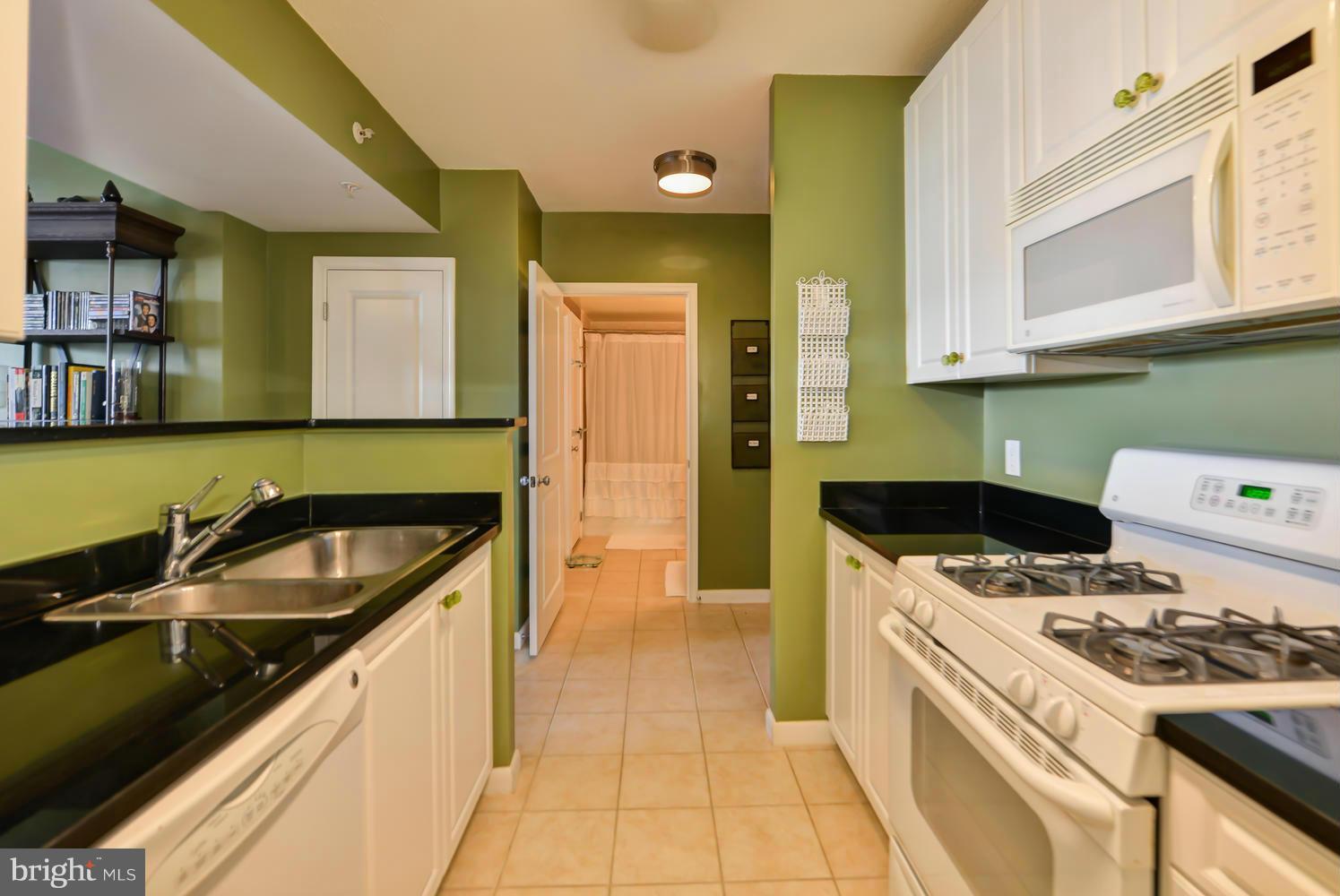 851 North Glebe Road, Unit 902 Arlington, VA 22203 - Photo 11 of 30 a kitchen that has a sink and a stove
