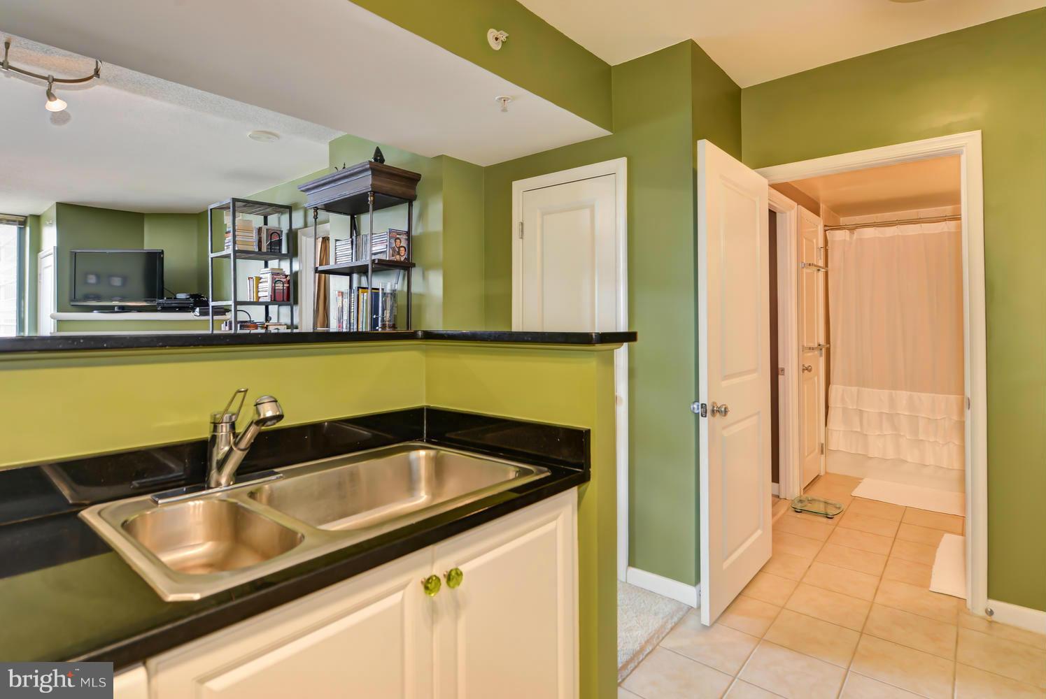 851 North Glebe Road, Unit 902 Arlington, VA 22203 - Photo 12 of 30 a kitchen with a sink and a refrigerator
