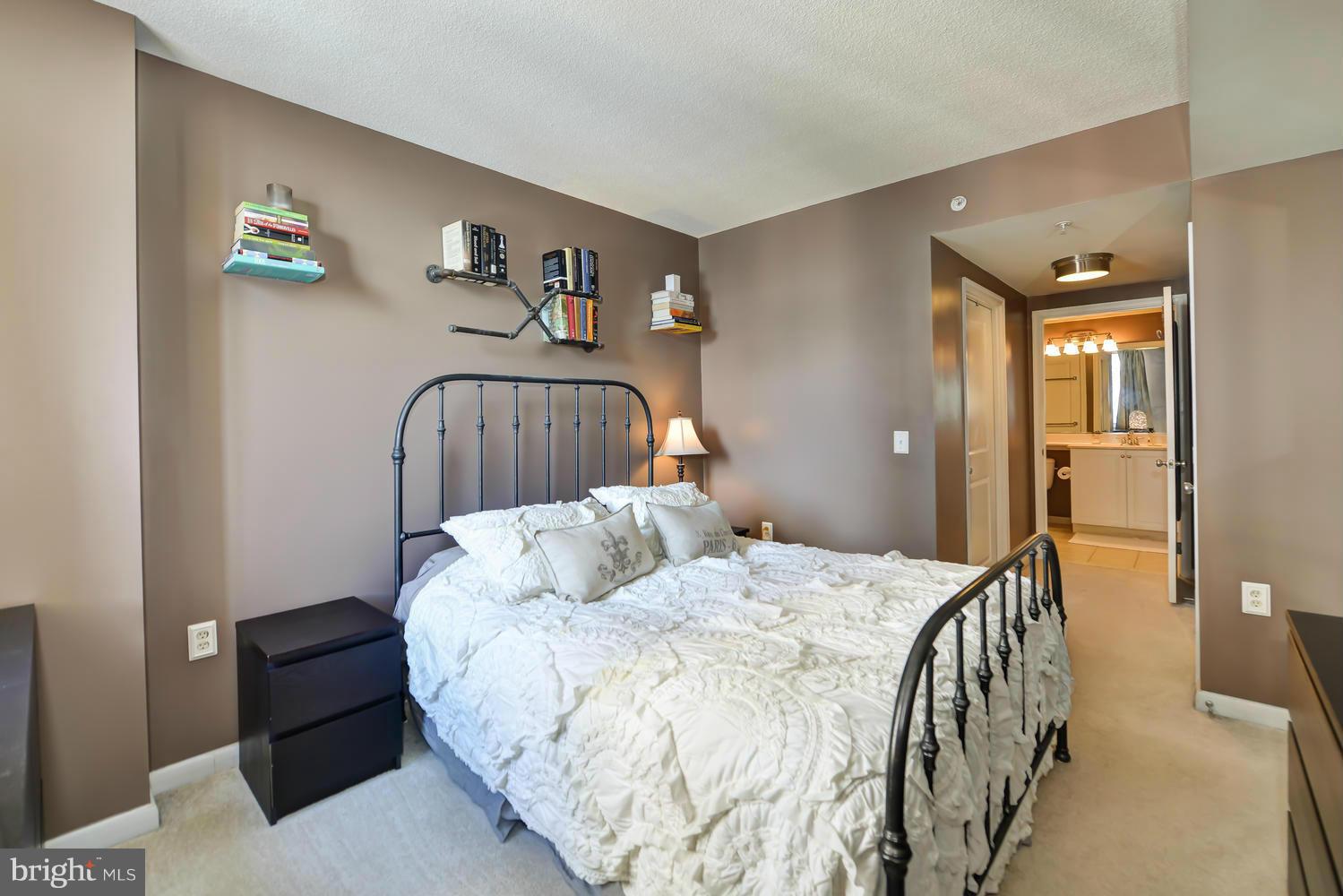 851 North Glebe Road, Unit 902 Arlington, VA 22203 - Photo 14 of 30 a bedroom with a bed and a table