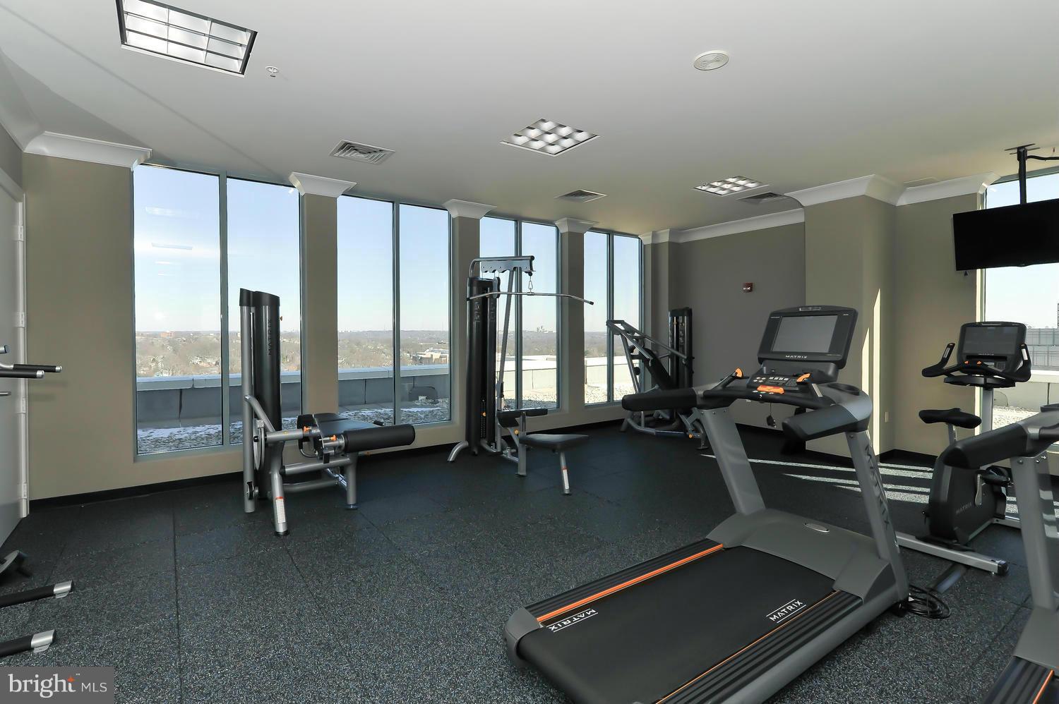 851 North Glebe Road, Unit 902 Arlington, VA 22203 - Photo 19 of 30 a room with gym equipment and a large window