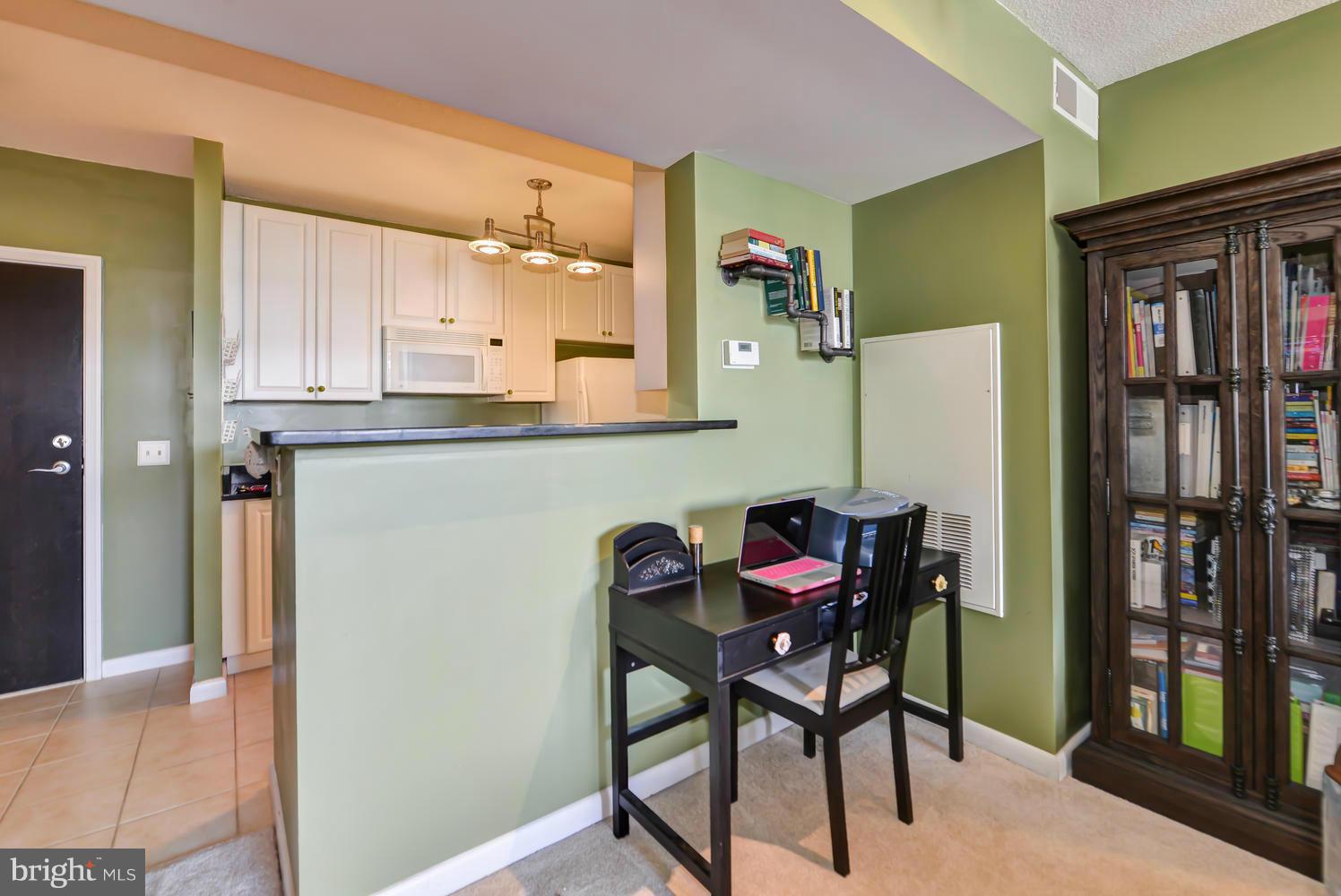 851 North Glebe Road, Unit 902 Arlington, VA 22203 - Photo 6 of 30 a view of dining room and kitchen with a table and chairs