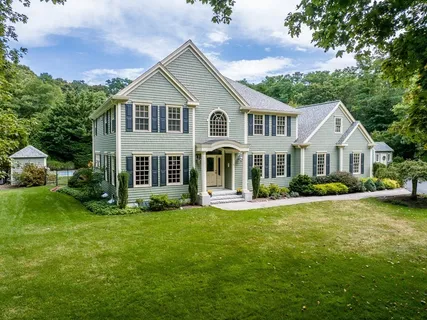a view of a house with a yard and porch