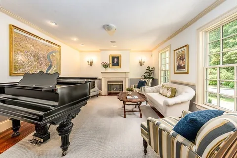 a living room with furniture a window and a fireplace