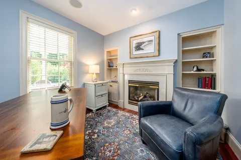 a view of a room with furniture and wooden floor