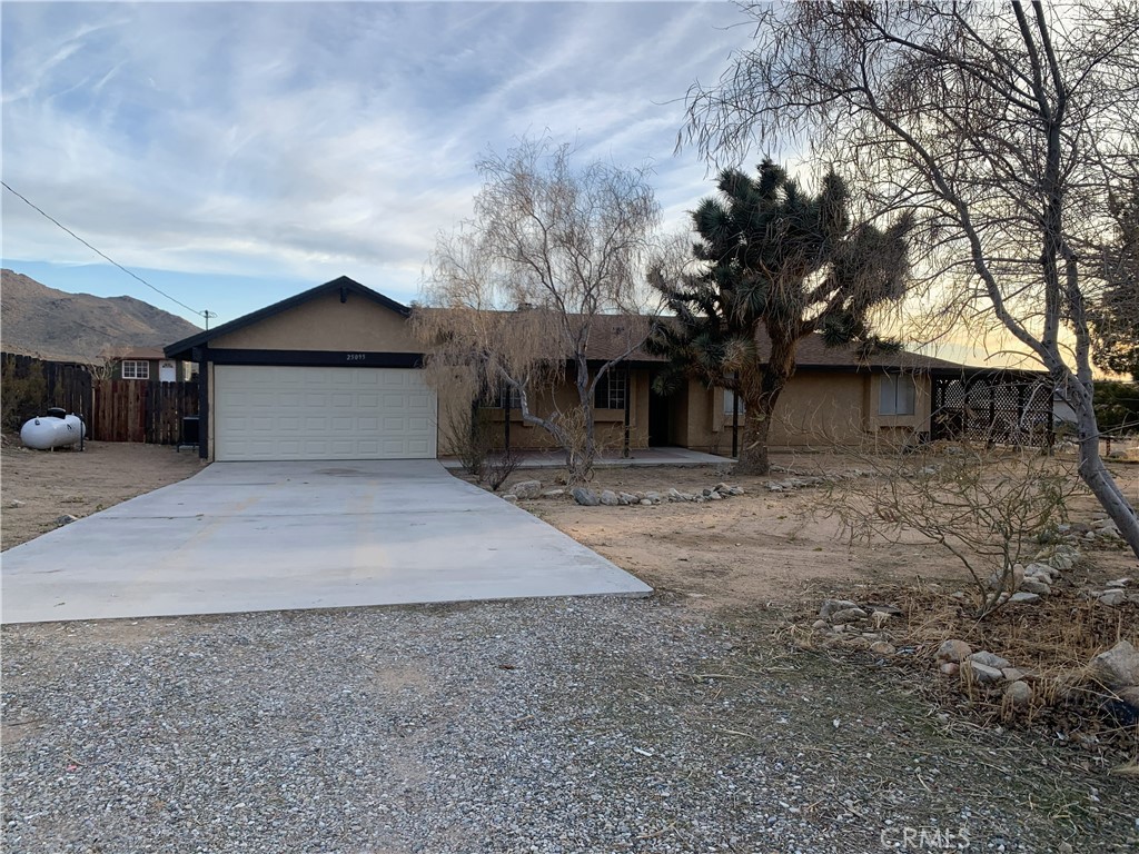 25095 Via Vista Road Apple Valley, CA 92307 - Photo 1 of 1 a front view of a house with a yard and garage