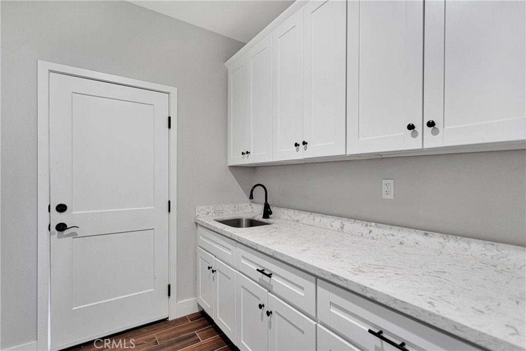 10055 Eaby Road Phelan, CA 92371 - Photo 11 of 19 a kitchen with white cabinets and a sink