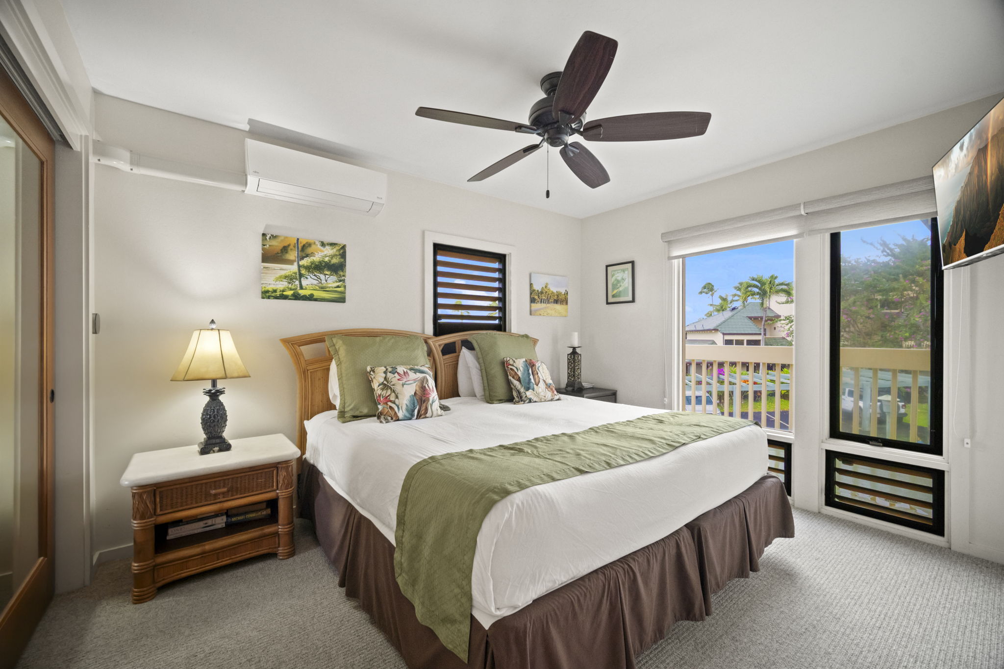 2371 Ho'ohu Road, Unit 610 Koloa, HI 96756 - Photo 17 of 29 a bedroom with a bed and a chandelier