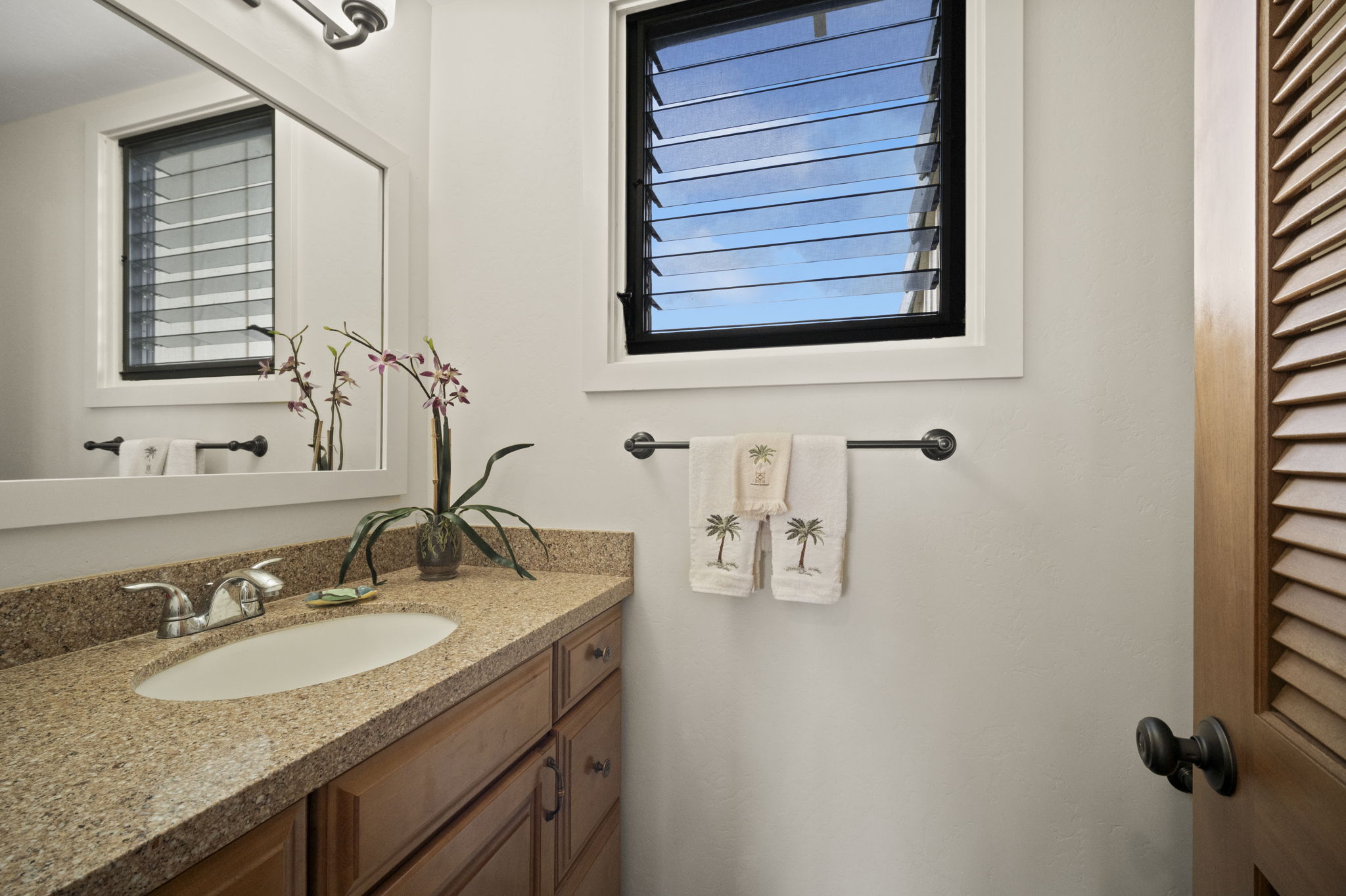 2371 Ho'ohu Road, Unit 610 Koloa, HI 96756 - Photo 10 of 29 a bathroom with a granite countertop sink and a mirror