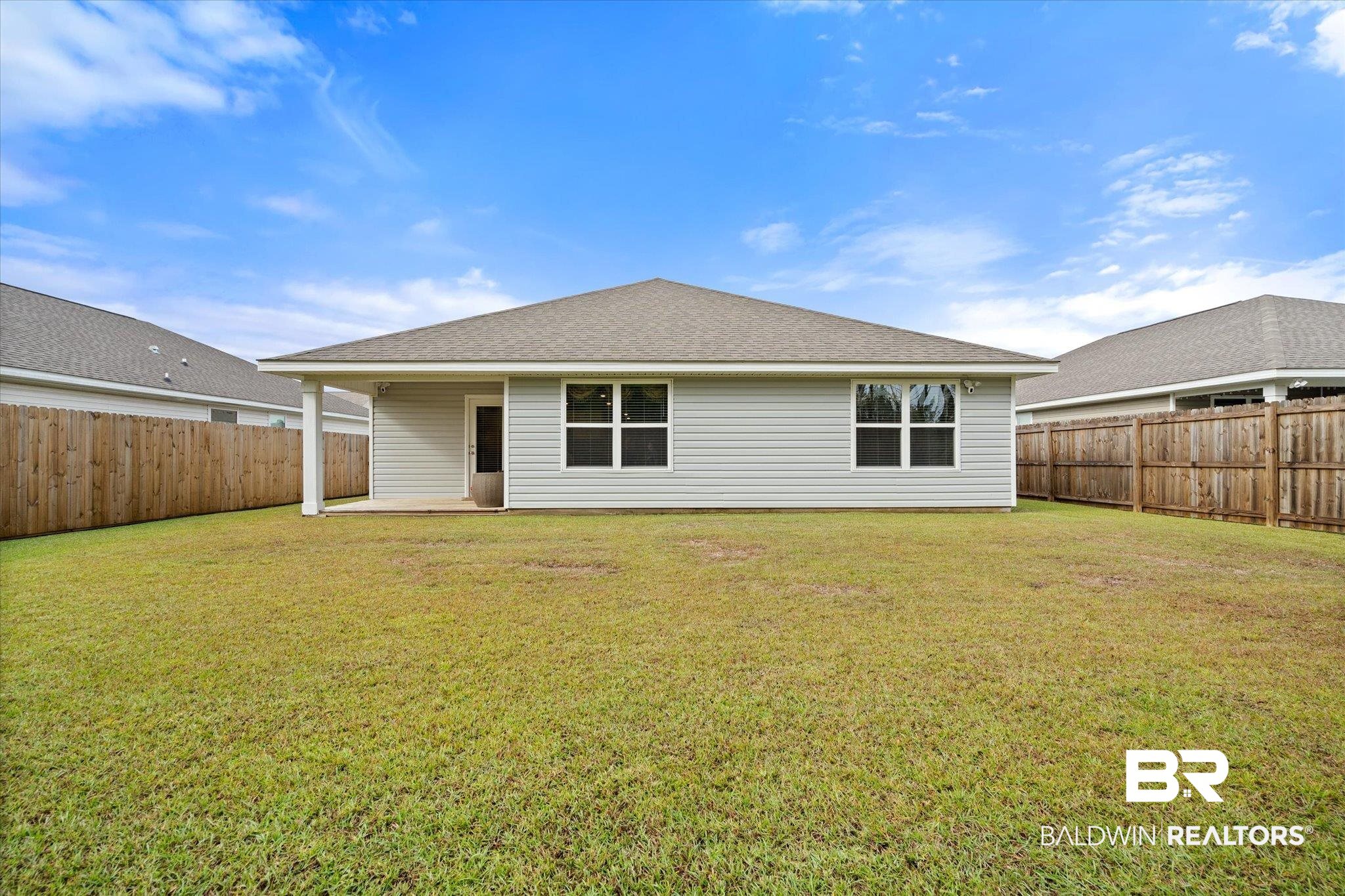 446 Paget Drive East Mobile, AL 36608 - Photo 19 of 20 Rear view of house featuring a lawn