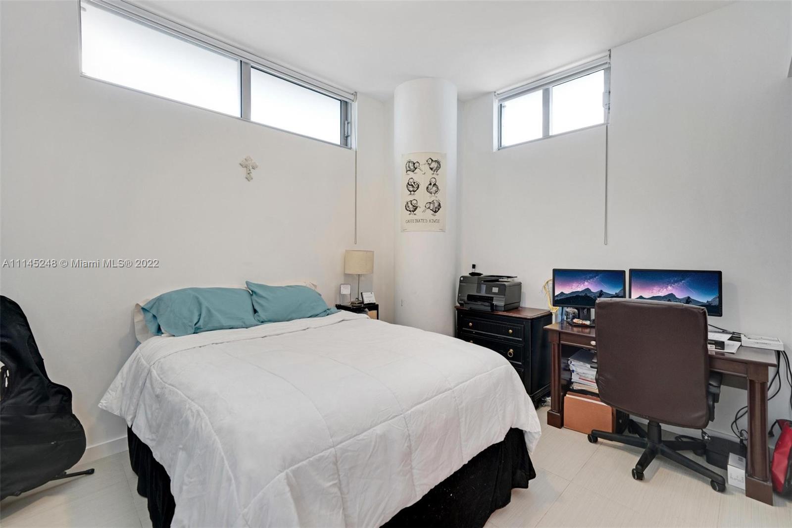 92 Southwest 3rd Street, Unit 901 Miami, FL 33130 - Photo 18 of 35 a bedroom with a bed and a desk