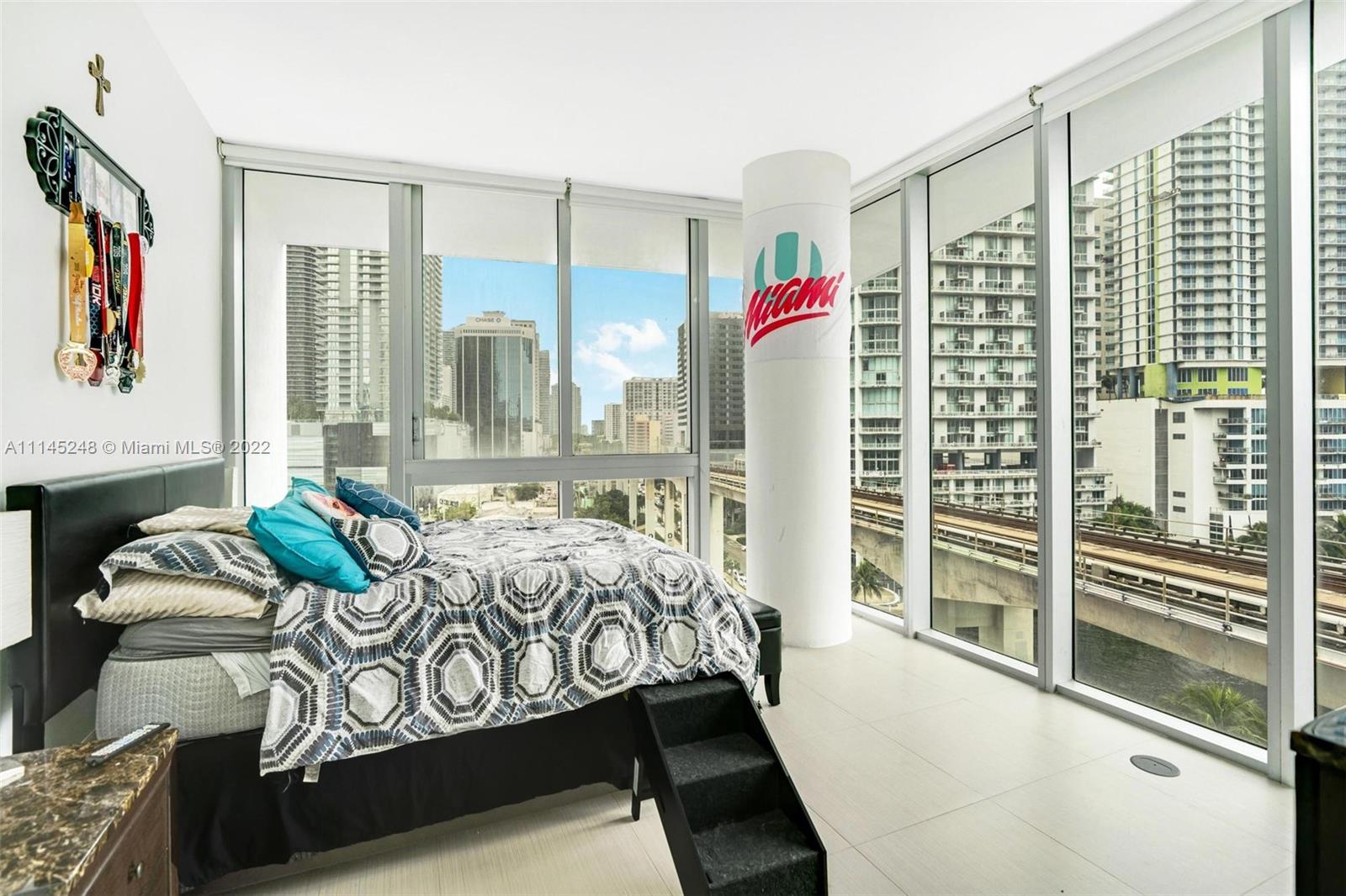92 Southwest 3rd Street, Unit 901 Miami, FL 33130 - Photo 20 of 35 a bedroom with furniture and a large window