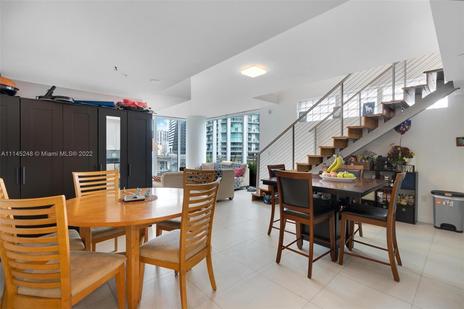 92 Southwest 3rd Street, Unit 901 Miami, FL 33130 - Photo 8 of 35 a dining room with furniture and wooden floor