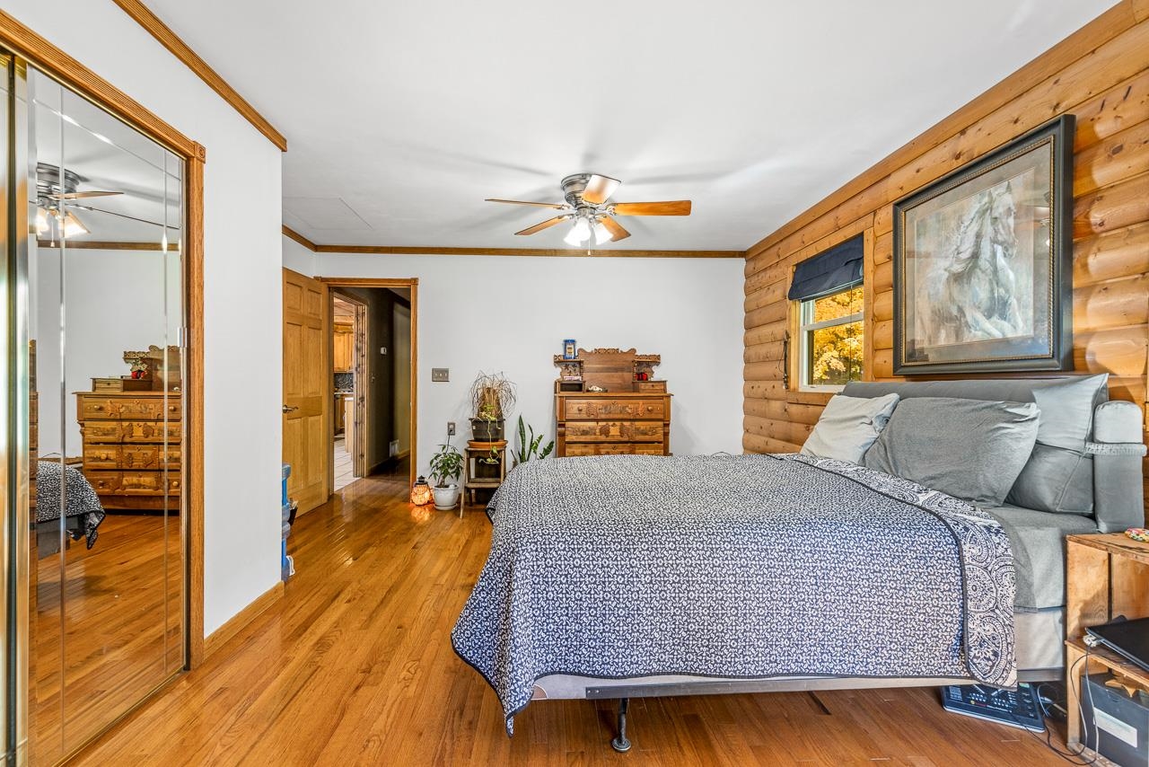 17097 Goodrich Road Davis, IL 61019 - Photo 11 of 45 a bedroom with a bed and wooden floor