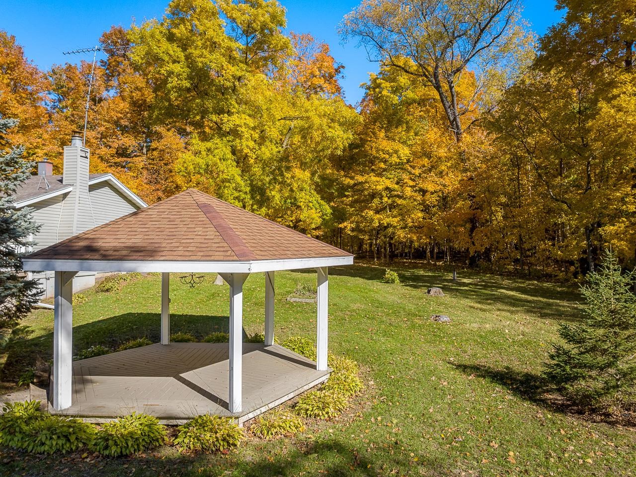 17097 Goodrich Road Davis, IL 61019 - Photo 9 of 45 a view of a patio with table and chairs under an umbrella